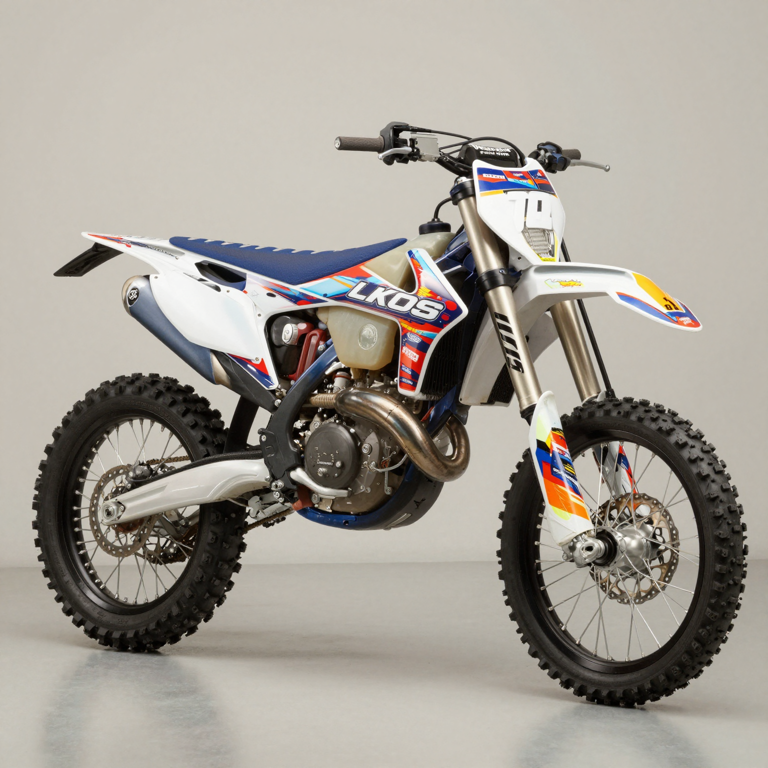 Custom dirt bike graphics kit showcasing premium side panel and number plate graphics on a high-performance dirt bike in a clean garage setting